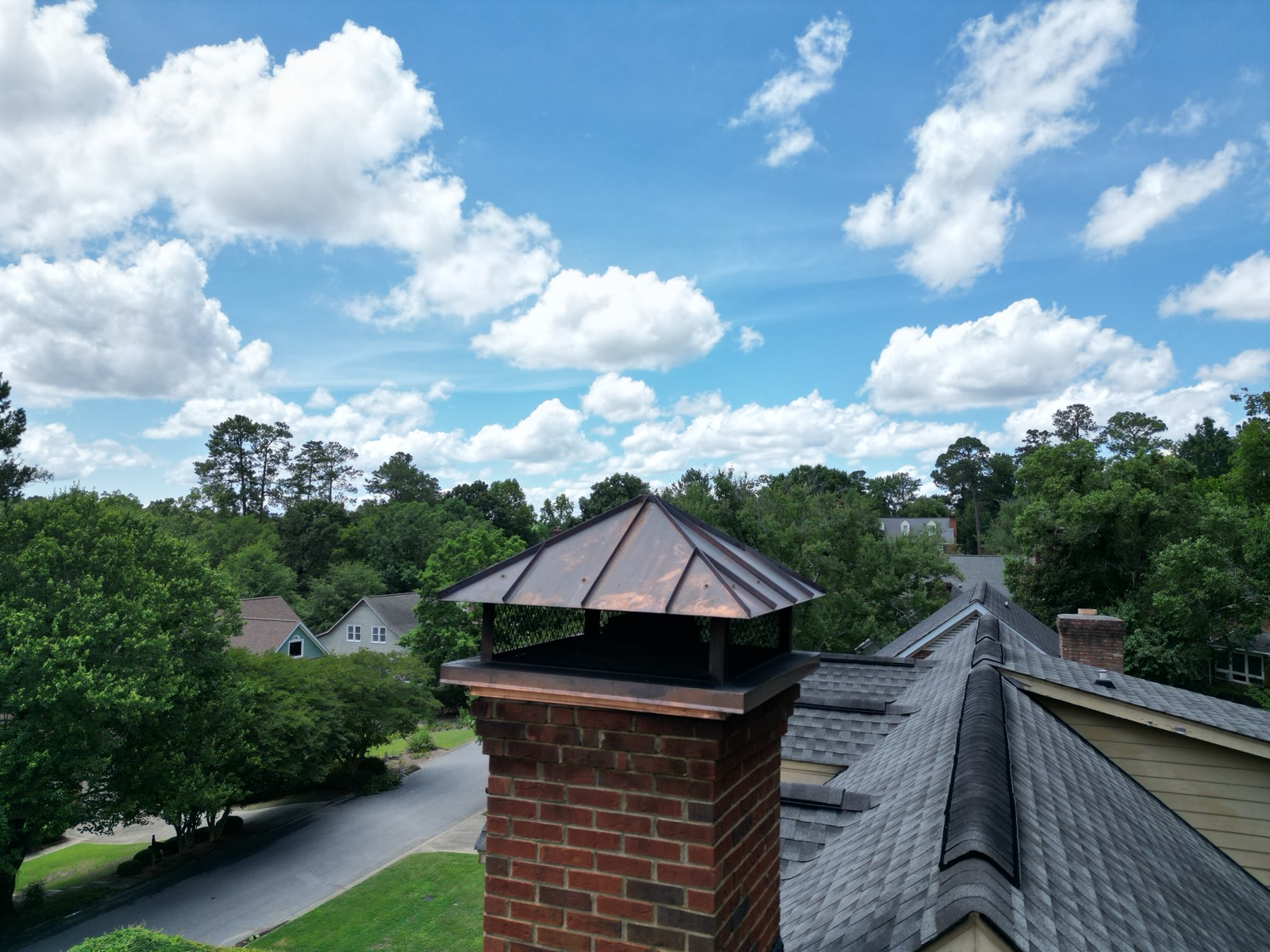 Aerial view of a chimney and copper cap on a Carolina rooftop
